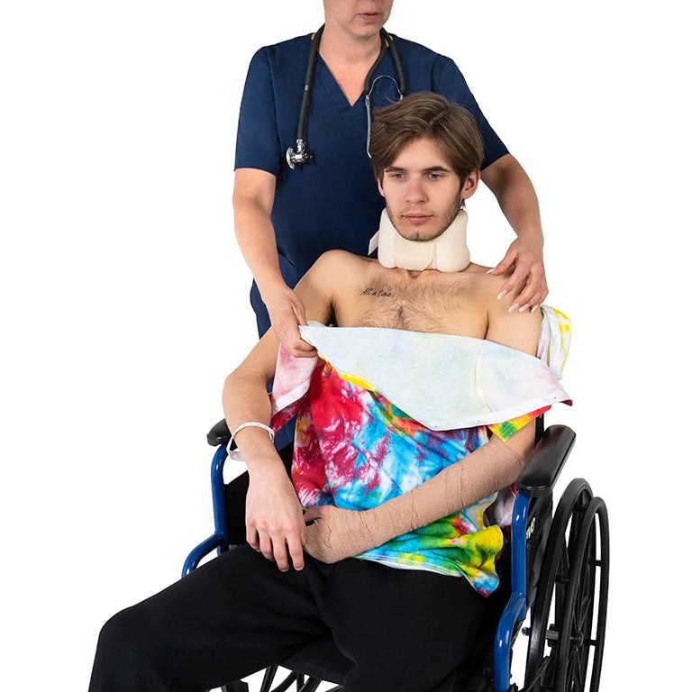 Person wearing black adaptive port access sleeve with medical tubing in a hospital or recovery setting
